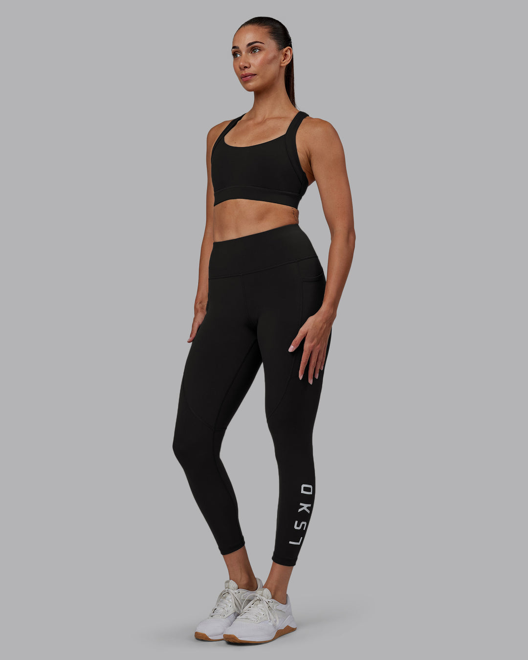 Woman wearing Rep Ultra High-Rise 7/8 Legging Pockets - Pirate Black-White | Model:Blaize | Size:S - view 1