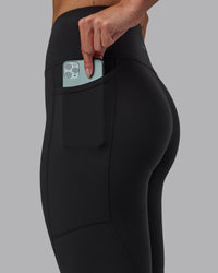Woman wearing Rep Ultra High-Rise 7/8 Legging Pockets - Pirate Black-White | Model:Blaize | Size:S | Thumbnail Index: 2