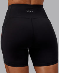 Woman wearing Rep Ultra High-Rise 6" Short Pockets - Black-Scarlet | Model:Demi | Size:S | Thumbnail Index: 4