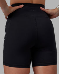 Woman wearing Rep Ultra High-Rise 6" Short Pockets - Black-White | Model:Shae | Size:S | Thumbnail Index: 9