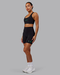 Woman wearing Rep Sports Bra - Black-Impact Green | Thumbnail Index: 2