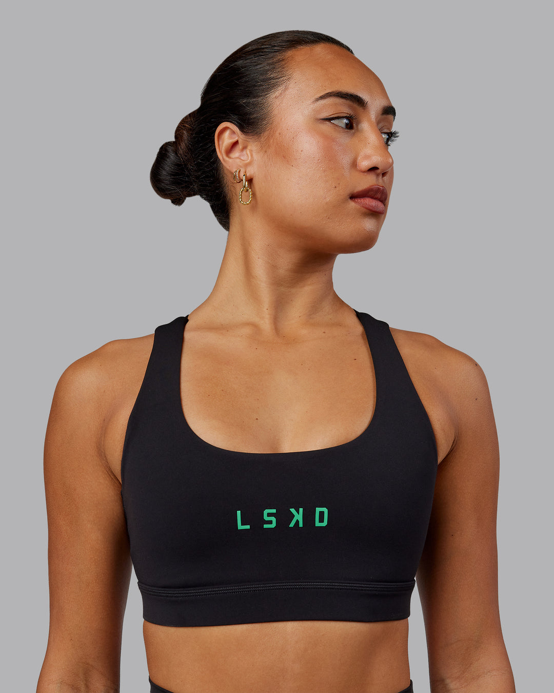 Woman wearing Rep Sports Bra - Black-Impact Green - view 1