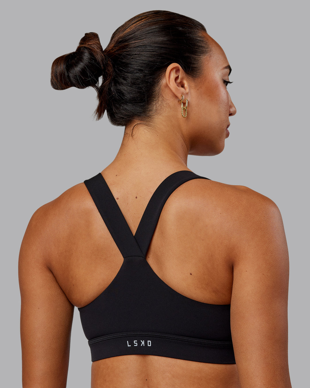 Woman wearing Rep Sports Bra - Black-Impact Green - view 2