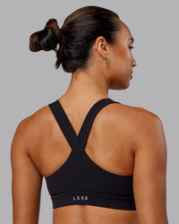 Woman wearing Rep Sports Bra - Black-Impact Green | Thumbnail Index: 1