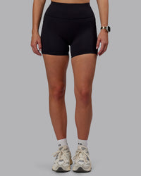 Woman wearing Rep Ultra High-Rise 4" Short Pockets - Black-Black | Model:Lillie | Size:S | Thumbnail Index: 6