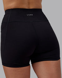 Woman wearing Rep Ultra High-Rise 4" Short Pockets - Black-Black | Model:Lillie | Size:S | Thumbnail Index: 7