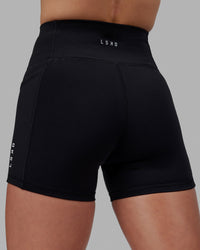 Women wearing O.G. Rep Ultra High-Rise 4" Short Pockets - Black-White | Model:Shae | Size:S | Thumbnail Index: 4