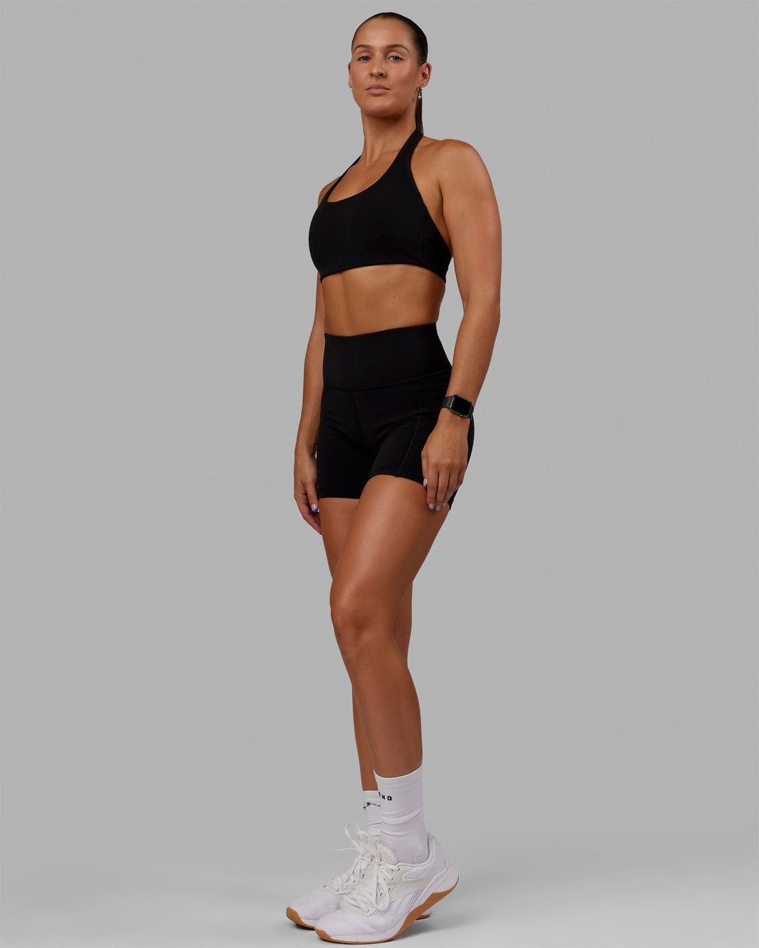 Woman wearing O.G. Rep Ultra High-Rise 4" Short Pockets - Black-Black | Model:Abbey| Size:S - view 2