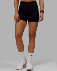 Woman wearing O.G. Rep Ultra High-Rise 4" Short Pockets - Black-Black | Model:Abbey| Size:S | Thumbnail Index: 0