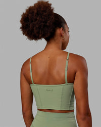 Woman wearing Resistance Ribbed Shelf Bra Performance Tank - Bayleaf | Thumbnail Index: 4