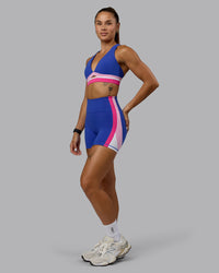 Woman wearing Revitalise Sports Bra - Power Cobalt-Fuchsia Pink | Thumbnail Index: 3