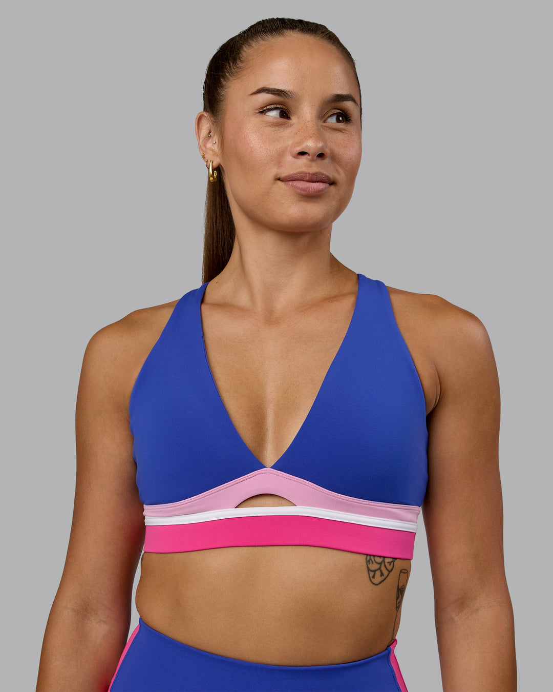 Woman wearing Revitalise Sports Bra - Power Cobalt-Fuchsia Pink - view 1