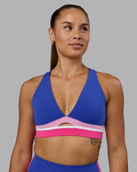 Woman wearing Revitalise Sports Bra - Power Cobalt-Fuchsia Pink | Thumbnail Index: 0