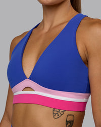 Woman wearing Revitalise Sports Bra - Power Cobalt-Fuchsia Pink | Thumbnail Index: 6