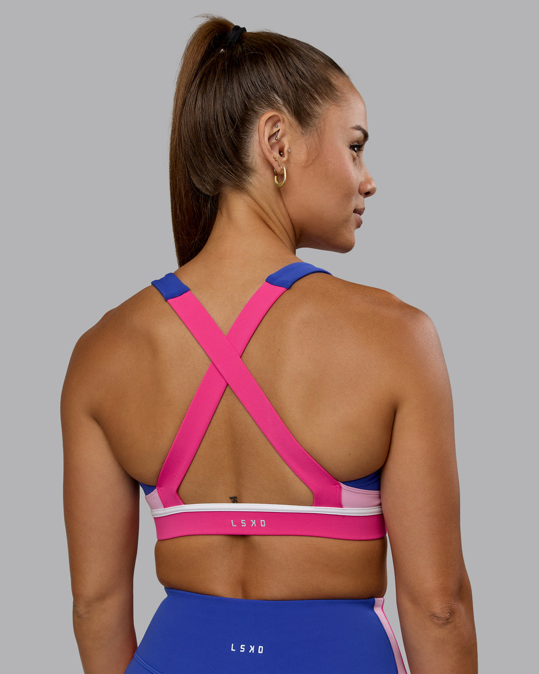 Woman wearing Revitalise Sports Bra - Power Cobalt-Fuchsia Pink - view 6