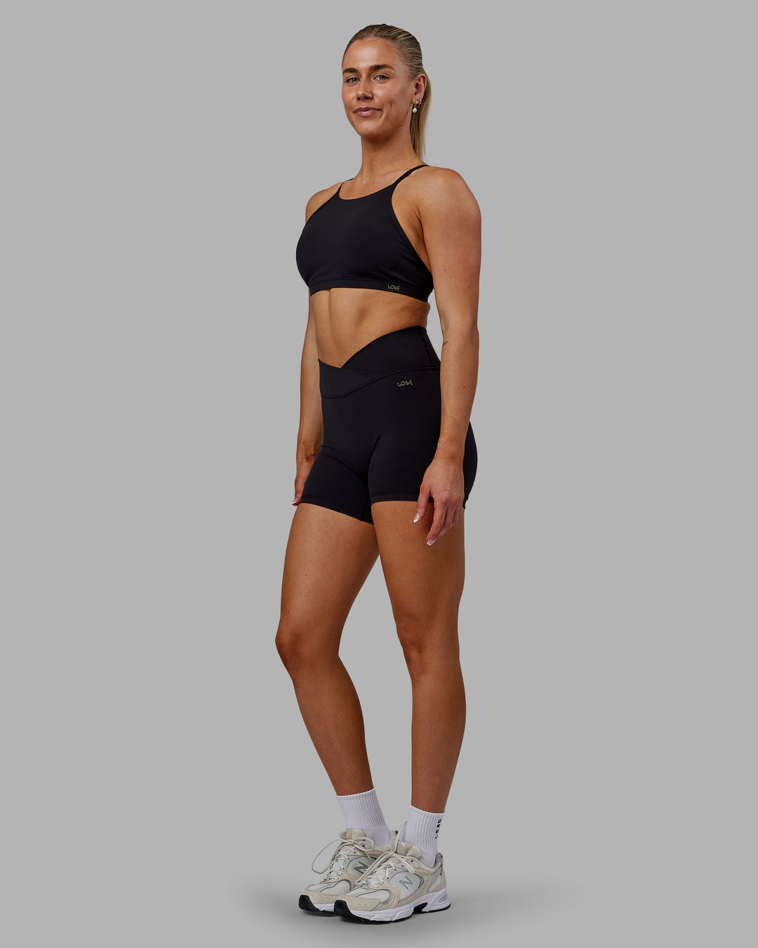 Woman wearing Sara Ares High Neck Sports Bra - Black - view 8