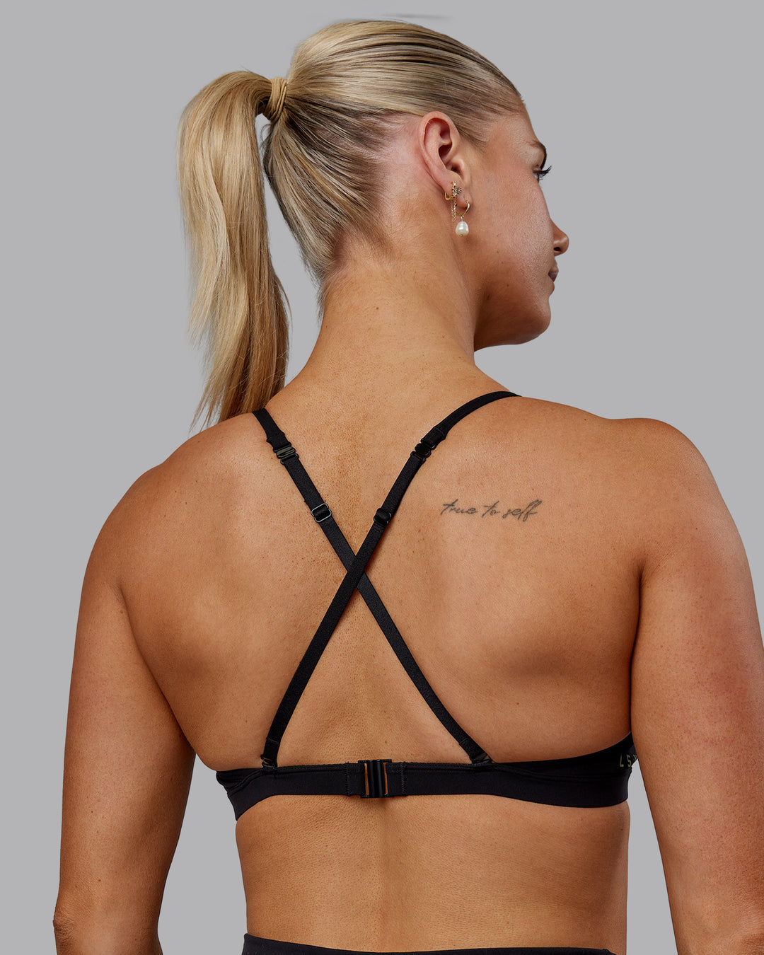 Woman wearing Sara Ares High Neck Sports Bra - Black - view 2