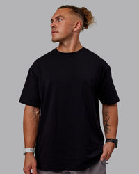 Man wearing Sara GET ÆTLA SKAL Unisex FLXCotton Tee Oversize - Black-White | Thumbnail Index: 3
