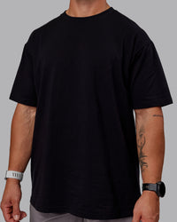 Man wearing Sara GET ÆTLA SKAL Unisex FLXCotton Tee Oversize - Black-White | Thumbnail Index: 9