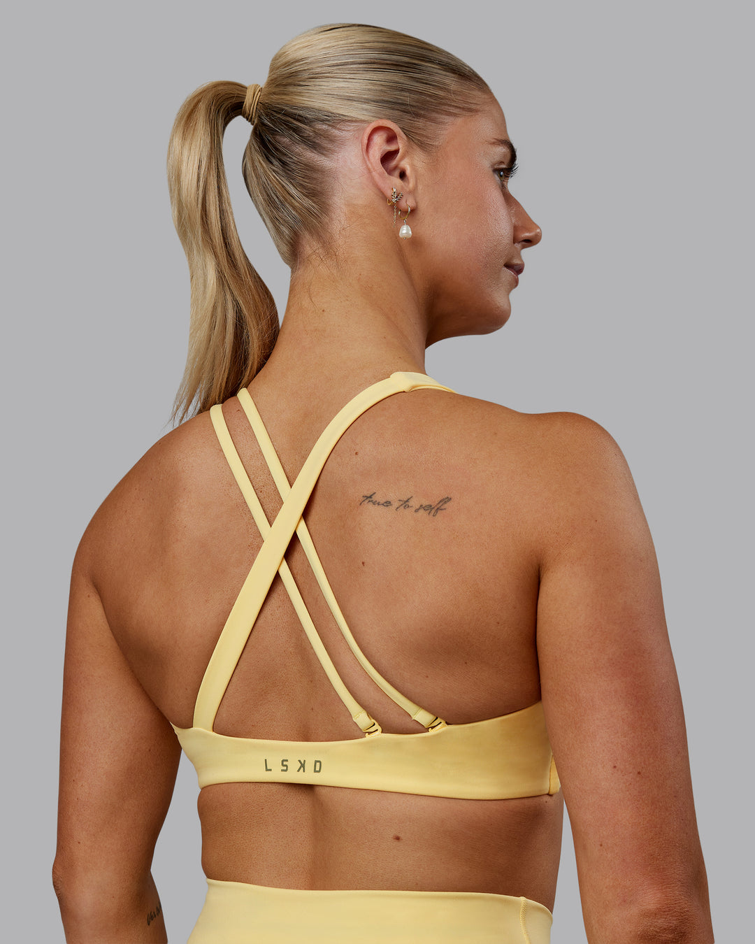Woman wearing Sara Helios Sports Bra - Sunflower - view 2