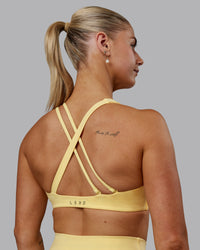 Woman wearing Sara Helios Sports Bra - Sunflower | Thumbnail Index: 1