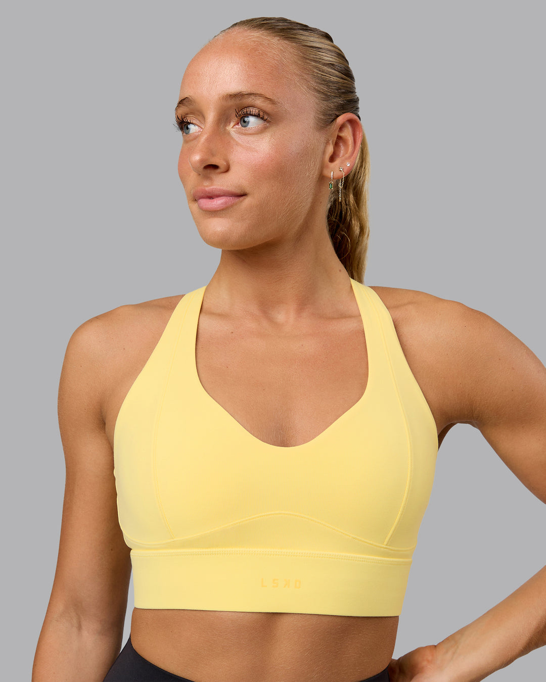 Woman wearing Sculpt Sports Bra - Lemon - view 1