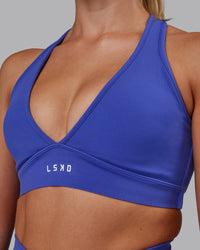 Woman wearing Stamina Sports Bra - Power Cobalt | Set:true | Angle:closeup | Model:Hannah | Size:S | Thumbnail Index: 3