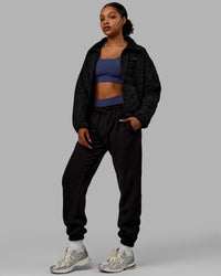 Woman wearing Thrive Packable Jacket - Black | Thumbnail Index: 9