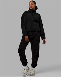Woman wearing Thrive Packable Jacket - Black | Thumbnail Index: 6