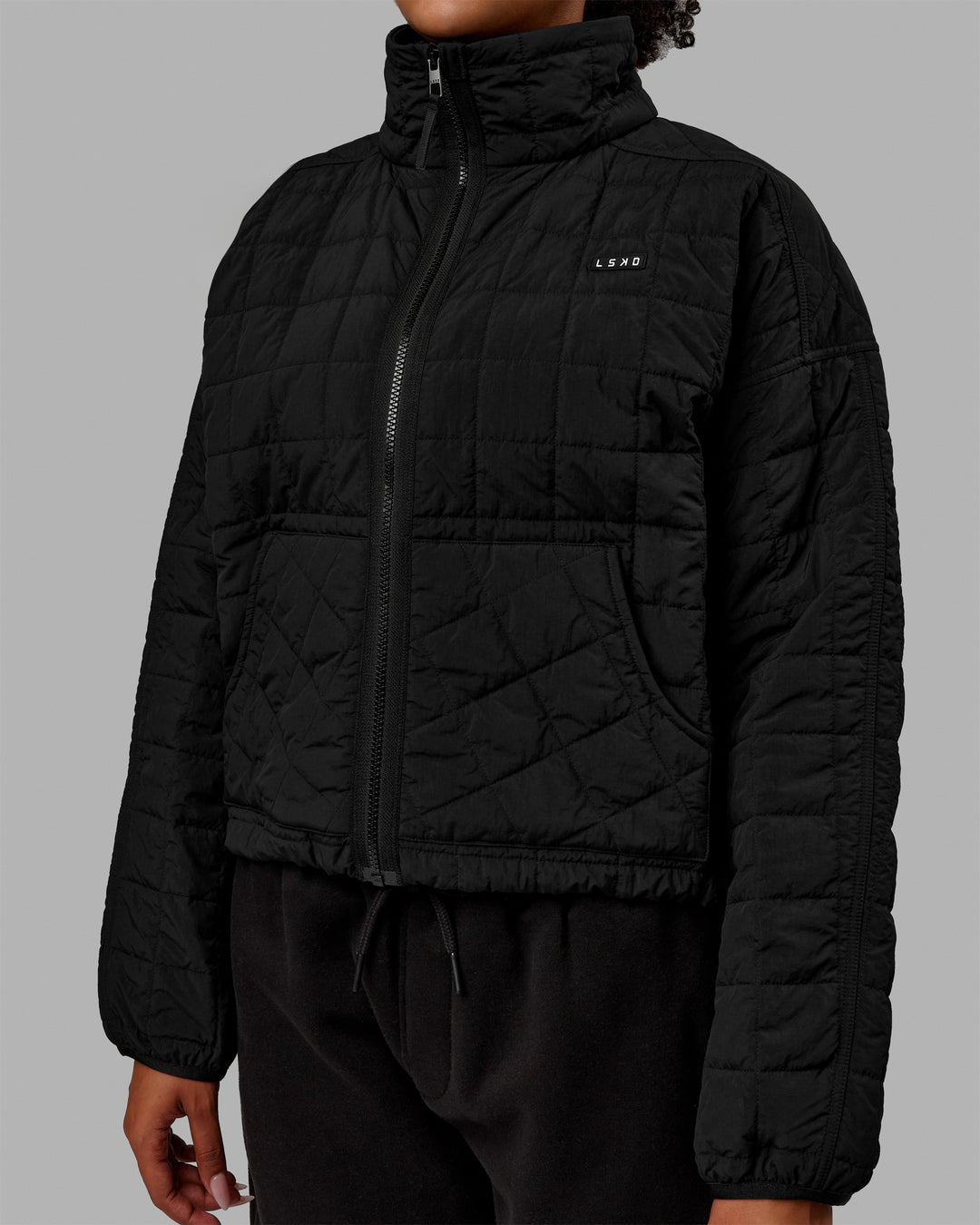 Woman wearing Thrive Packable Jacket - Black - view 11