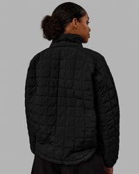 Woman wearing Thrive Packable Jacket - Black | Thumbnail Index: 3
