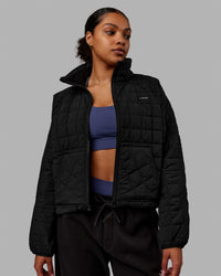 Woman wearing Thrive Packable Jacket - Black | Thumbnail Index: 0