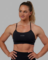 Woman wearing Lift Sports Bra - Black | Thumbnail Index: 0