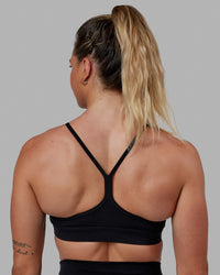 Woman wearing Lift Sports Bra - Black | Thumbnail Index: 1