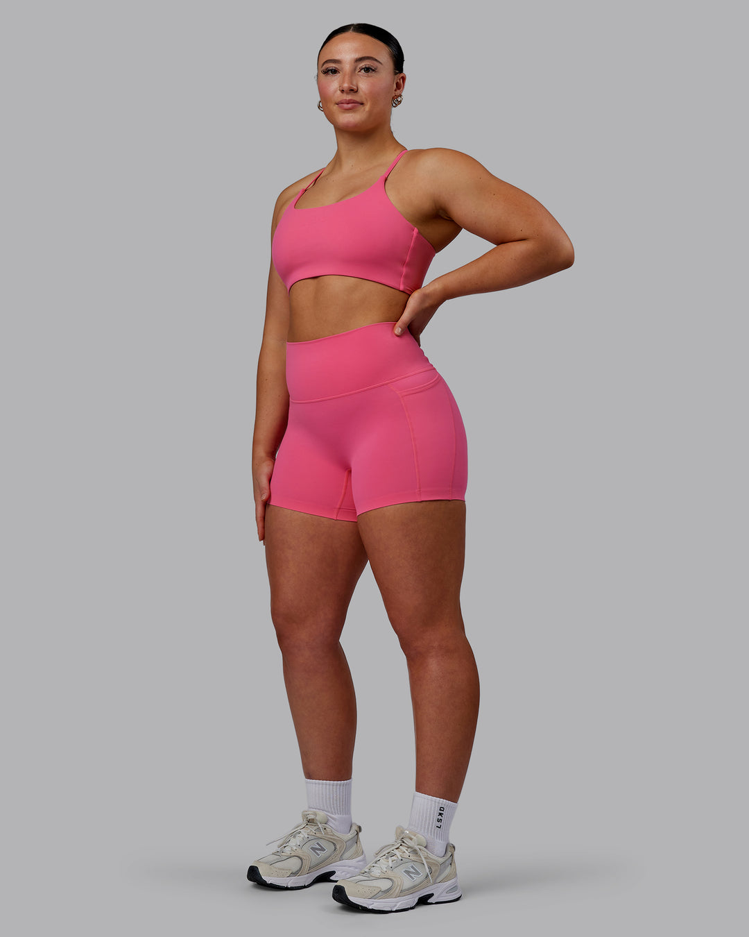 Woman wearing Twist Sports Bra - Carmine Rose - view 4