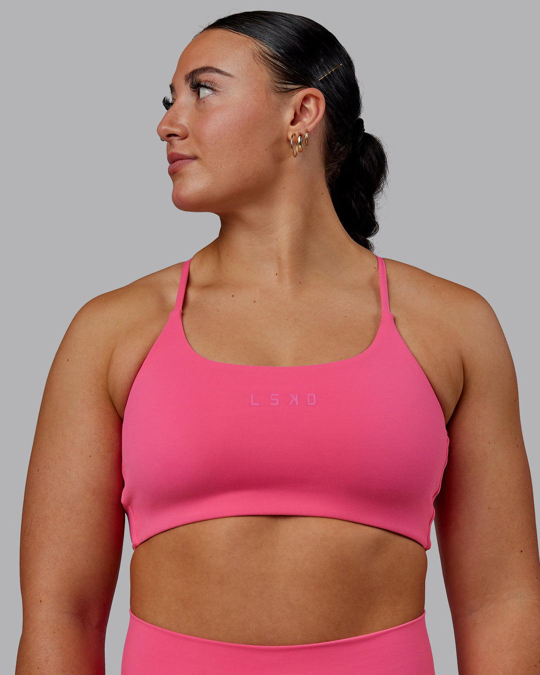 Woman wearing Twist Sports Bra - Carmine Rose - view 1