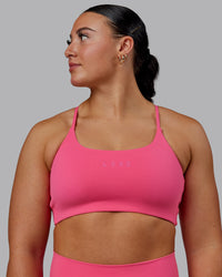 Woman wearing Twist Sports Bra - Carmine Rose | Thumbnail Index: 0