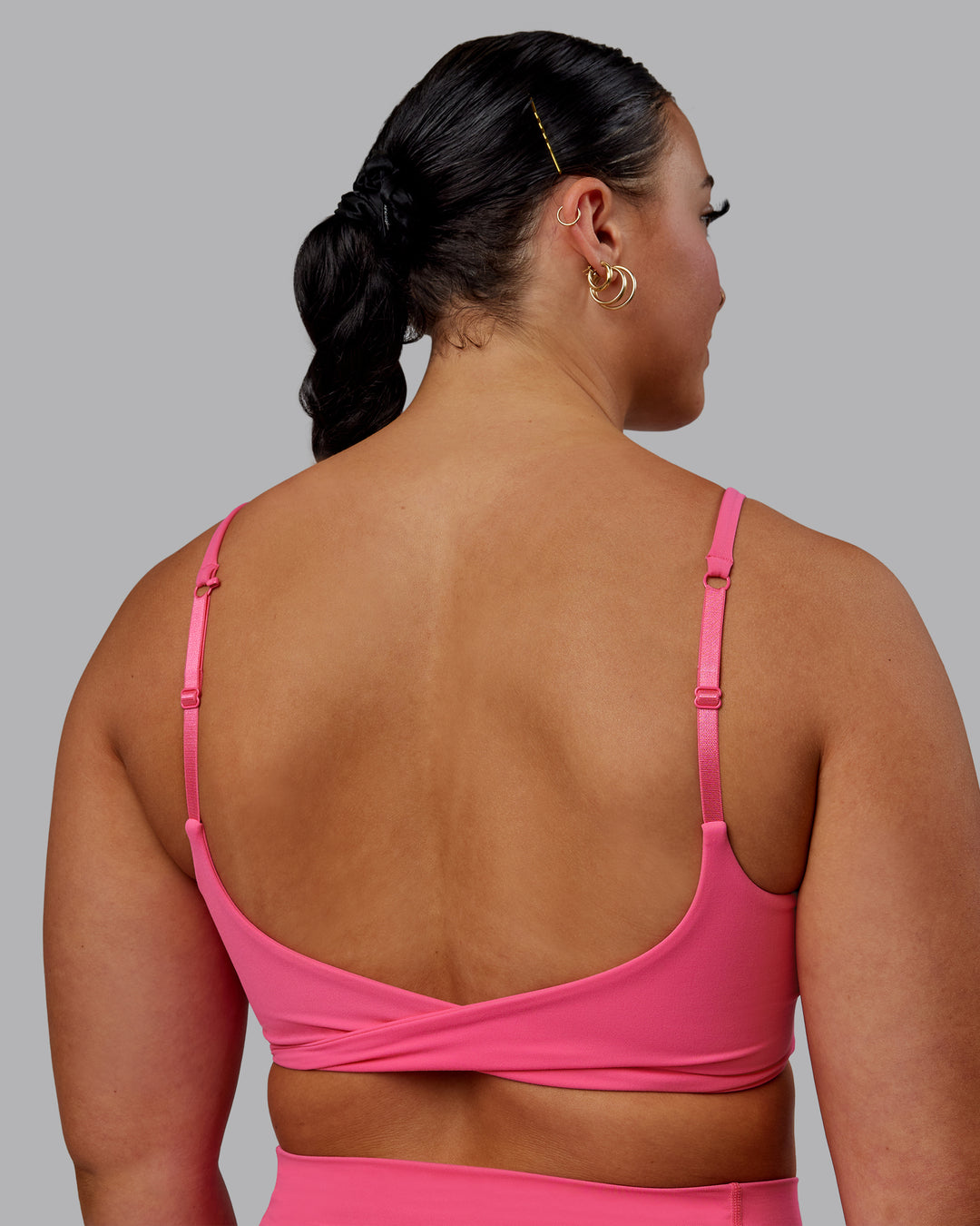 Woman wearing Twist Sports Bra - Carmine Rose - view 5