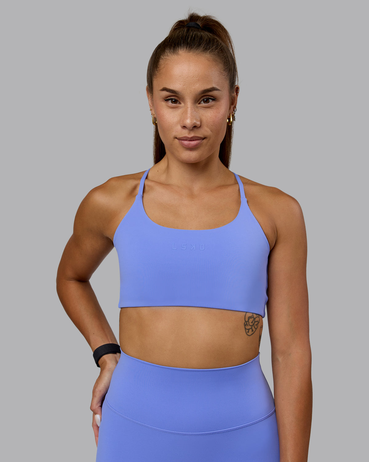 Woman wearing Twist Sports Bra - Indulgent Blue