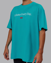 Woman wearing Unisex 1% Better FLXCotton Tee Oversize - Blue Bird-White | Thumbnail Index: 5