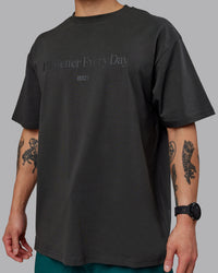 Man wearing Unisex 1% Better FLXCotton Tee Oversize - Pirate Black-Black | Thumbnail Index: 7