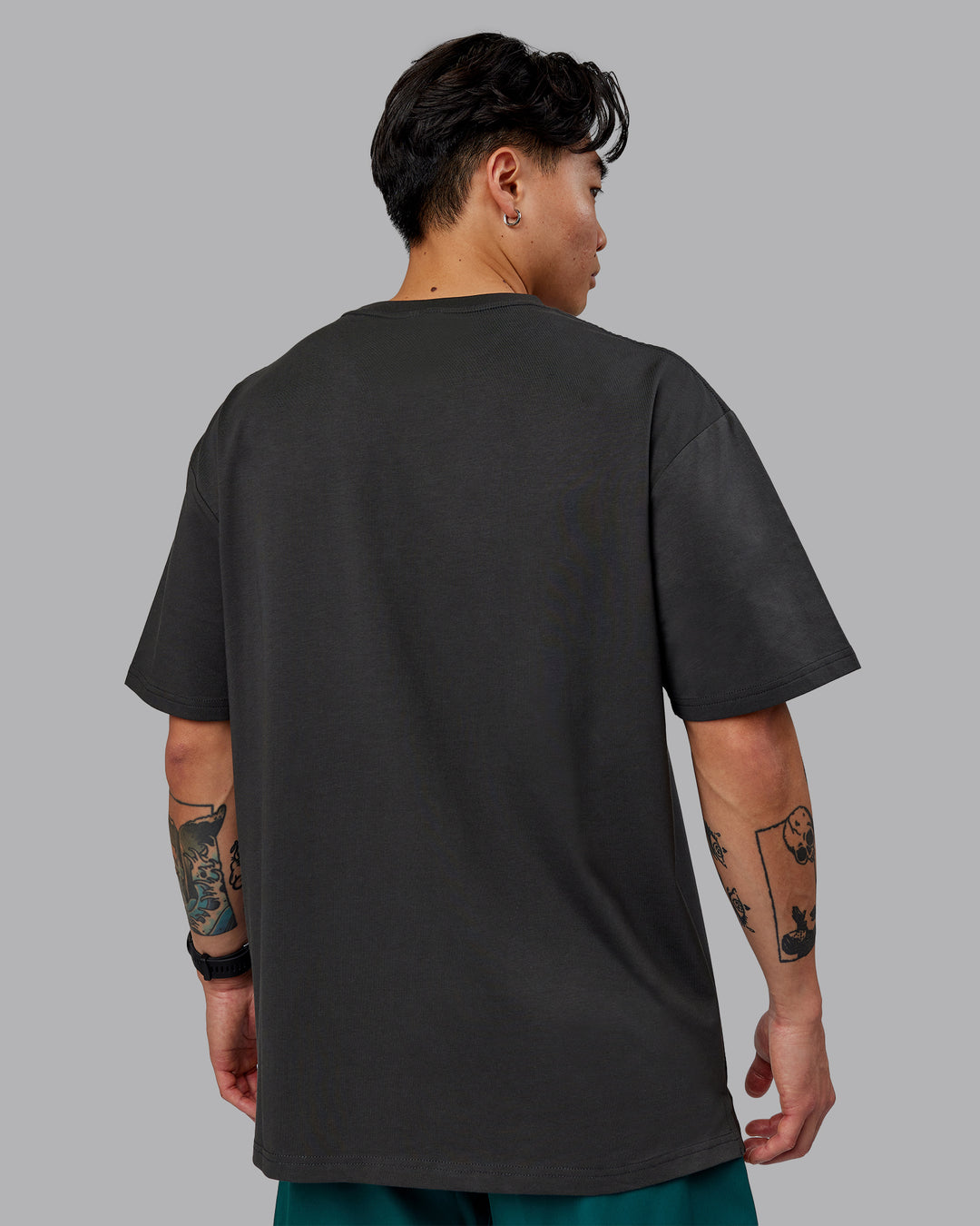 Man wearing Unisex 1% Better FLXCotton Tee Oversize - Pirate Black-Black - view 4