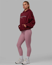Woman wearing Unisex 1% Better Hoodie Oversize - Cranberry-White | Thumbnail Index: 4