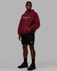 Man wearing Unisex 1% Better Hoodie Oversize - Cranberry-White | Thumbnail Index: 2