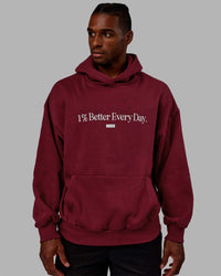 Man wearing Unisex 1% Better Hoodie Oversize - Cranberry-White | Thumbnail Index: 5