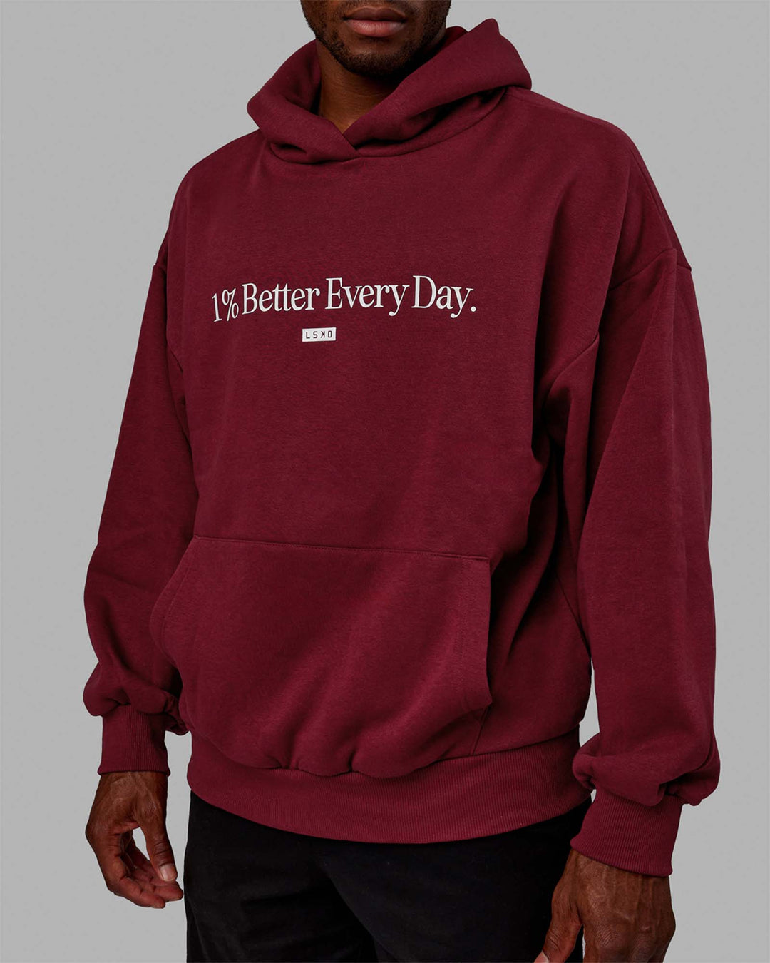 Man wearing Unisex 1% Better Hoodie Oversize - Cranberry-White - view 10
