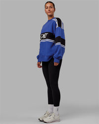 Woman wearing Unisex A-Team Sweater Oversize - Power Cobalt-Black | Thumbnail Index: 4