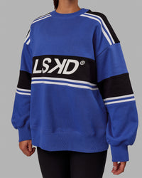 Woman wearing Unisex A-Team Sweater Oversize - Power Cobalt-Black | Thumbnail Index: 6