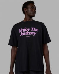 Man wearing Unisex Enjoy The Journey FLXCotton Tee Oversize - Black-Light Violet | Thumbnail Index: 4