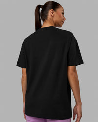Woman wearing Unisex Enjoy The Journey FLXCotton Tee Oversize - Black-Light Violet | Thumbnail Index: 3